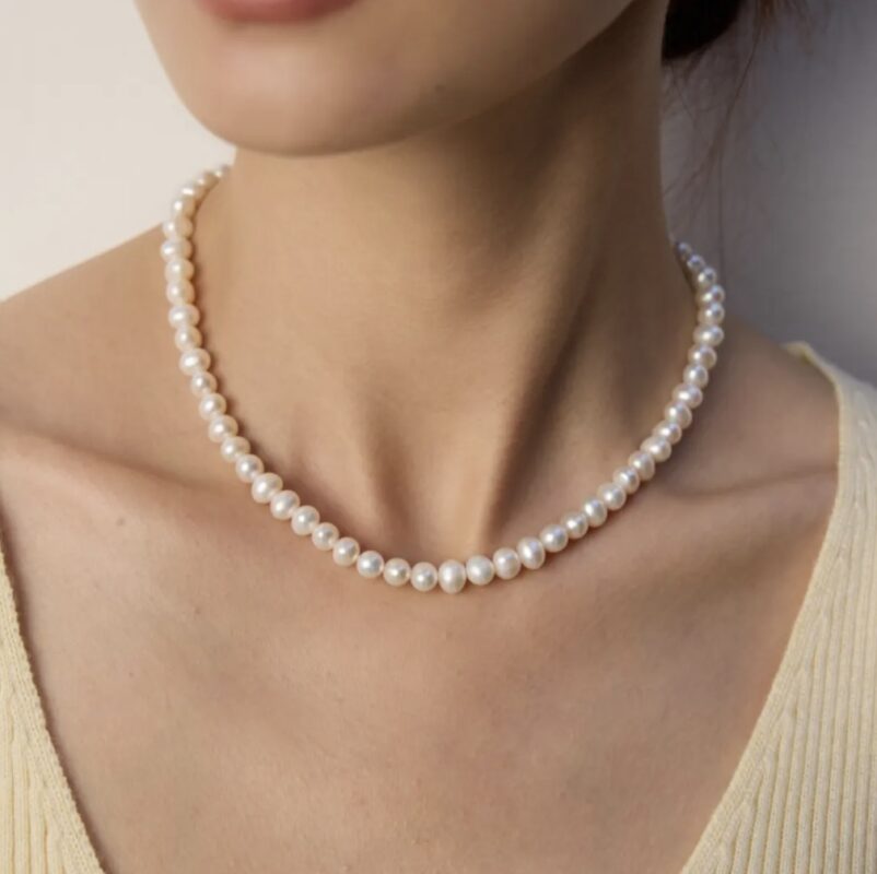 June birthstone jewelry, pearl necklace and moonstone earrings symbolizing purity and intuition